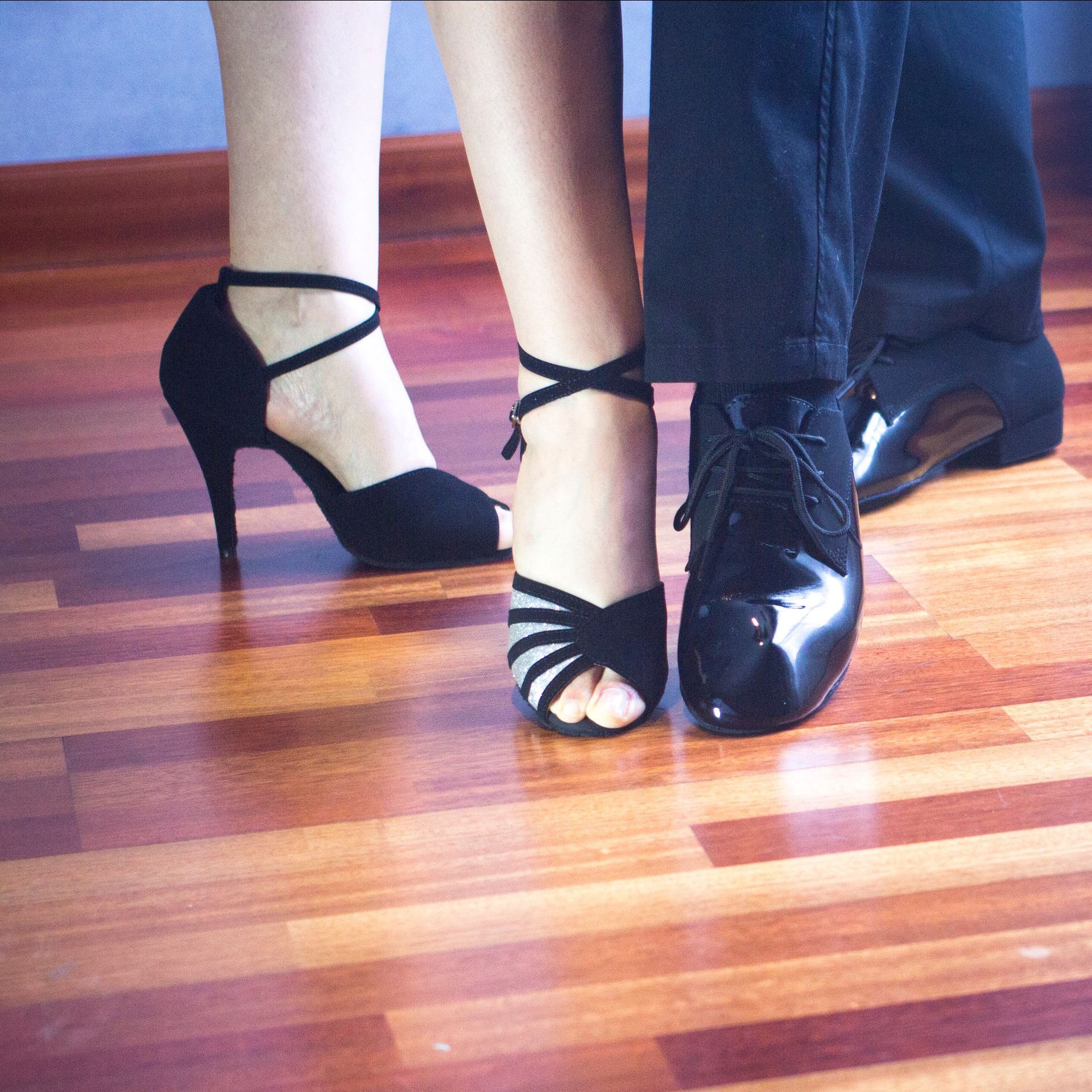Un homme et une femme dansent sur un plancher en bois