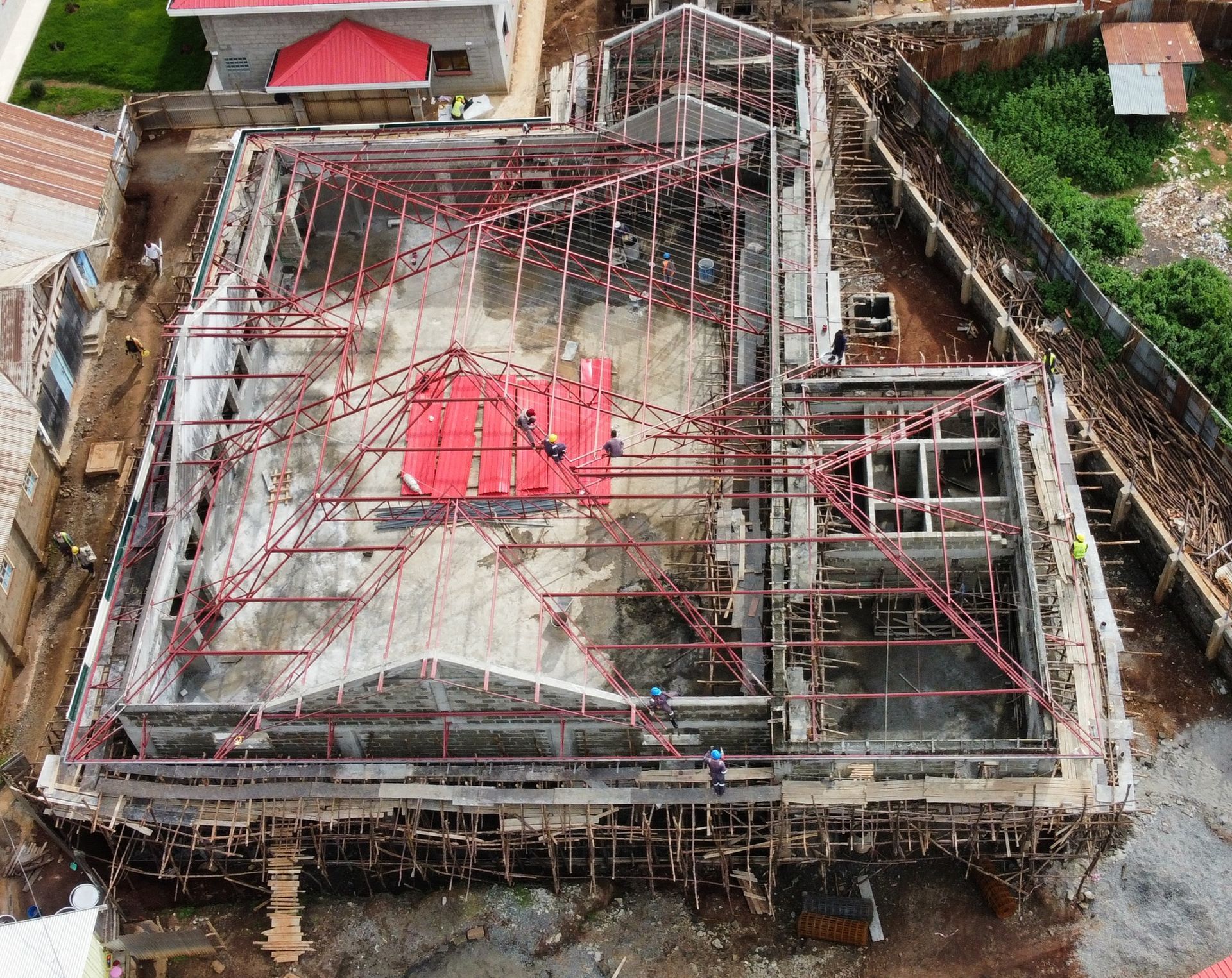 an aerial view of a building under construction with a red tarp on top .