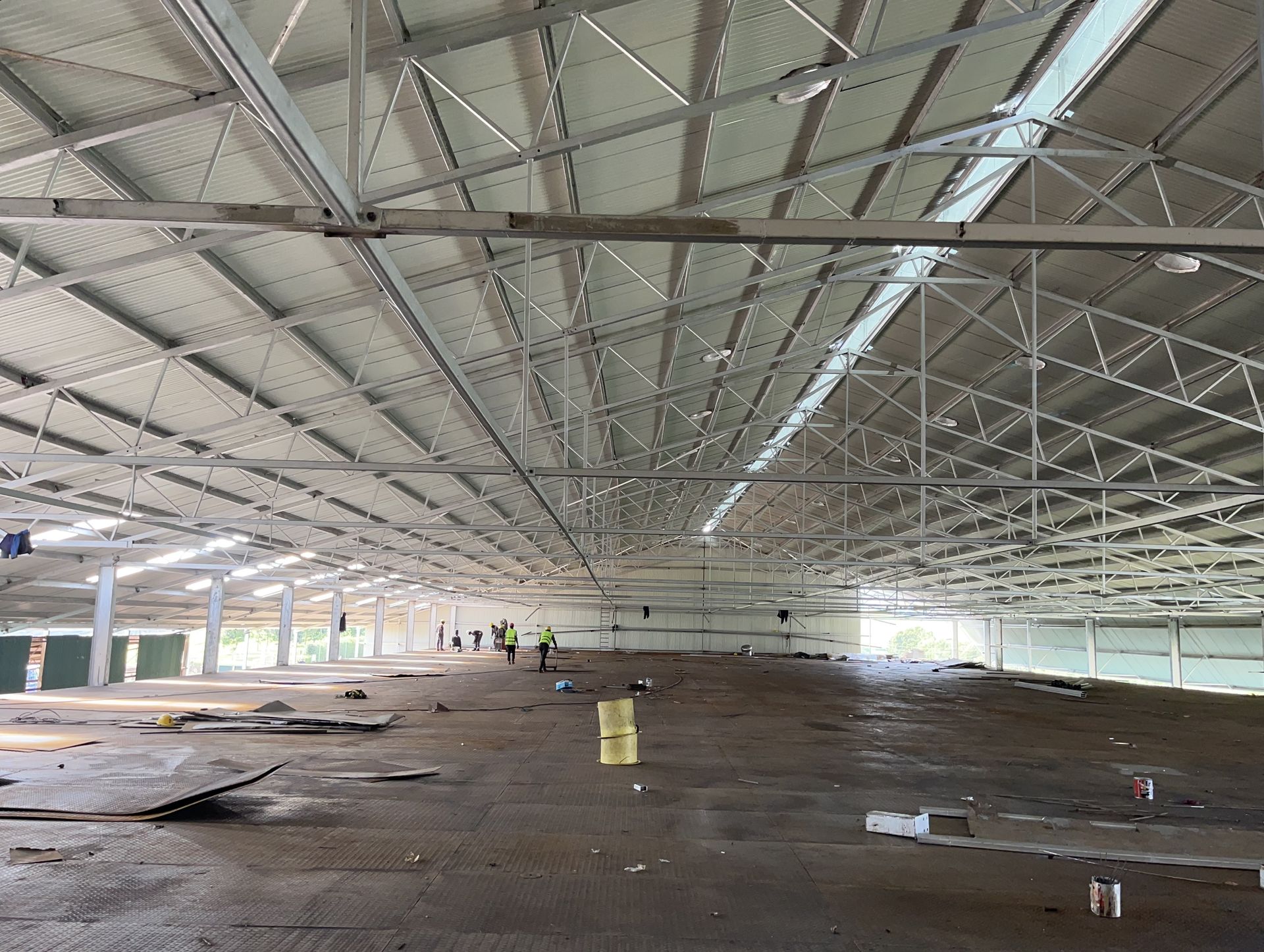 a large empty warehouse with a white roof