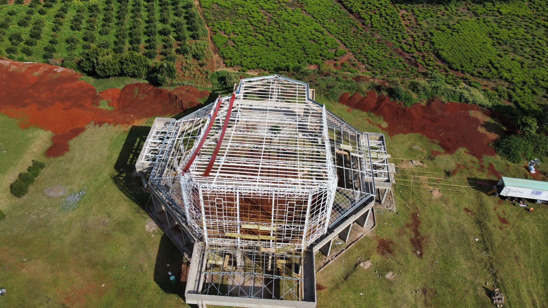 an aerial view of a building under construction in a field .