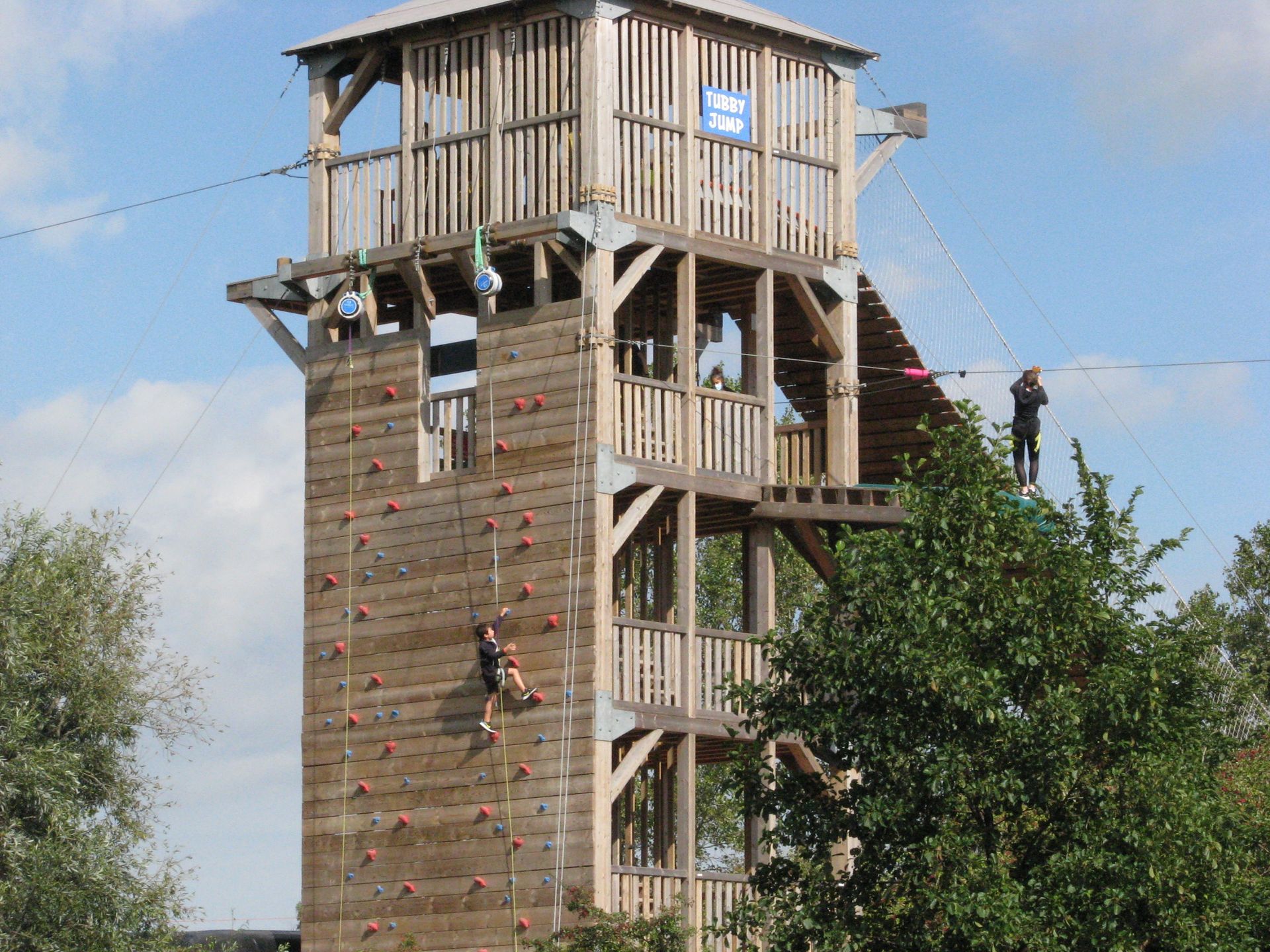 Tour en bois avec mur d'escalade et tyrolienne