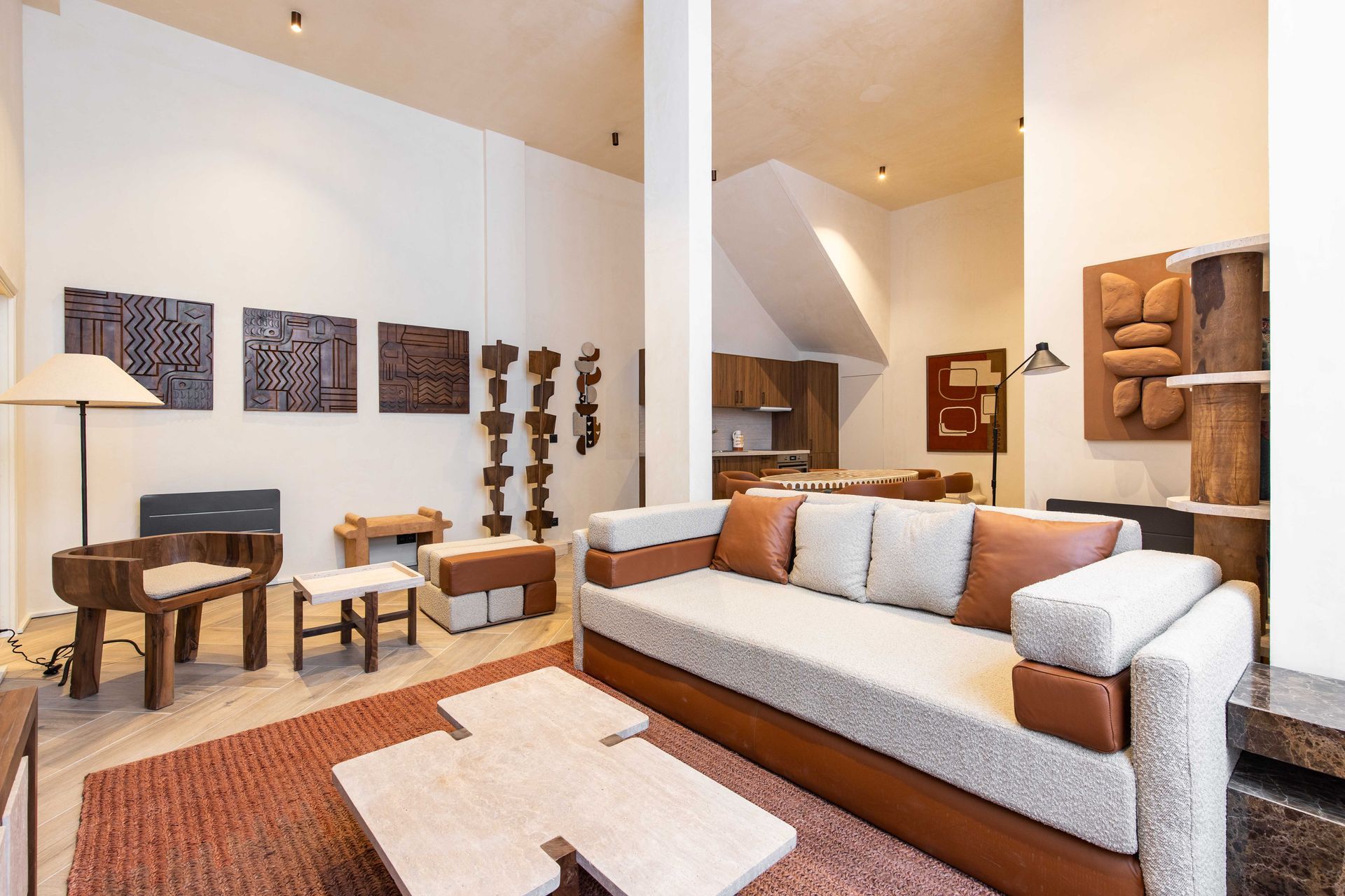 Living room with modern wood furniture and wall art. Brown, white, and tan color scheme.