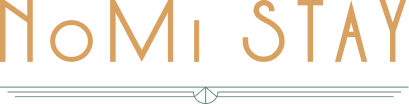 A logo for a hotel called nomi stay