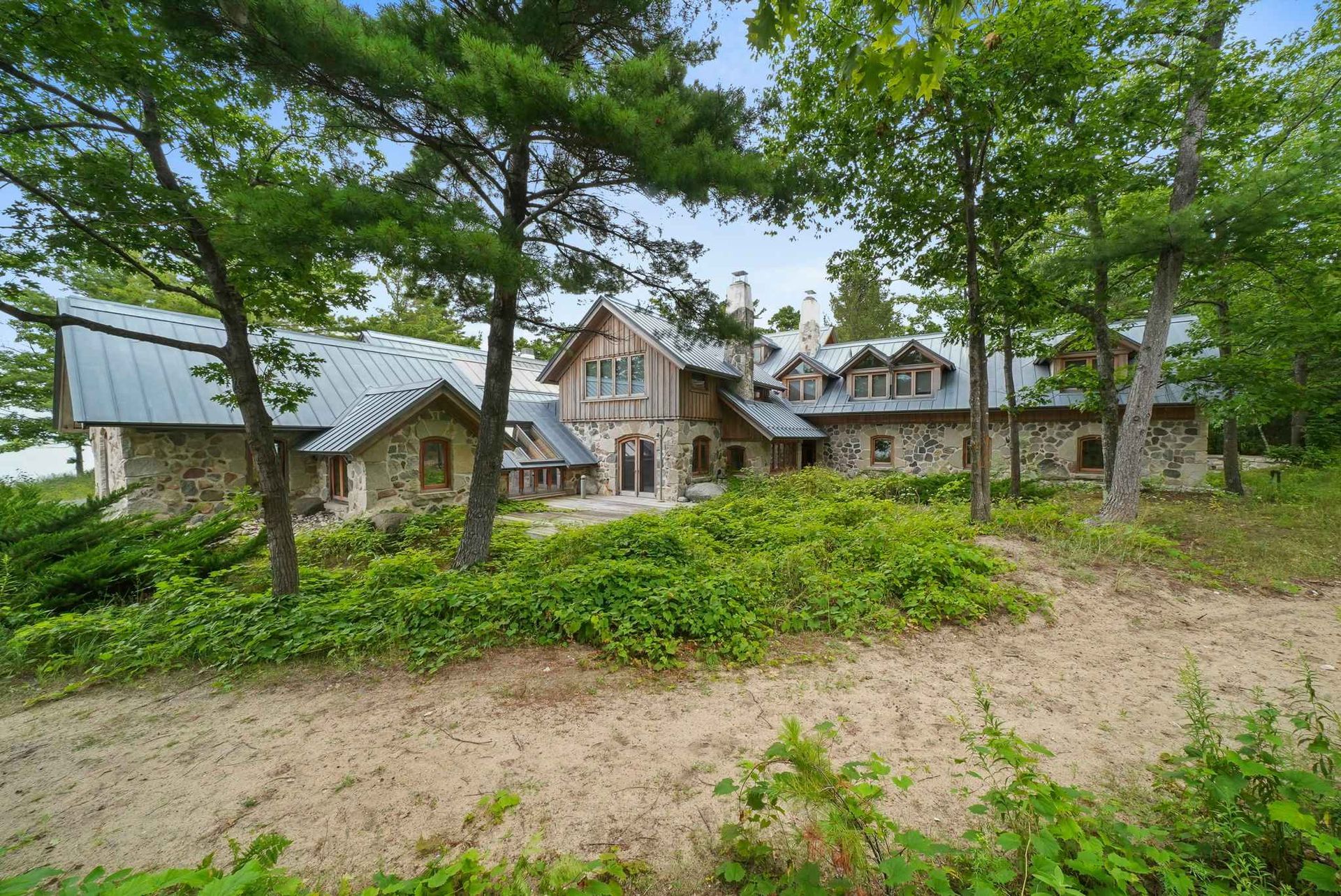 A large deck with a table and chairs overlooking a lake
