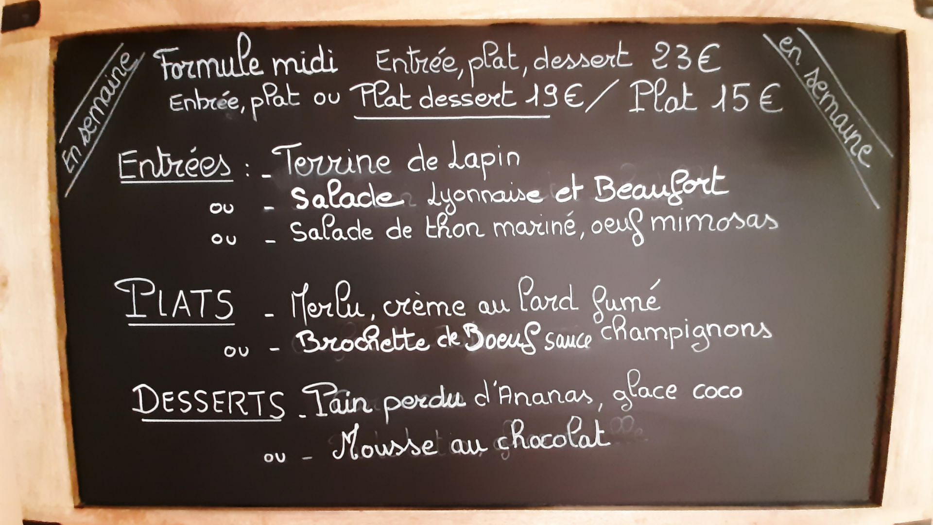 Une serveuse distribue les menus à un groupe de personnes assises à une table en bois dans un restaurant.