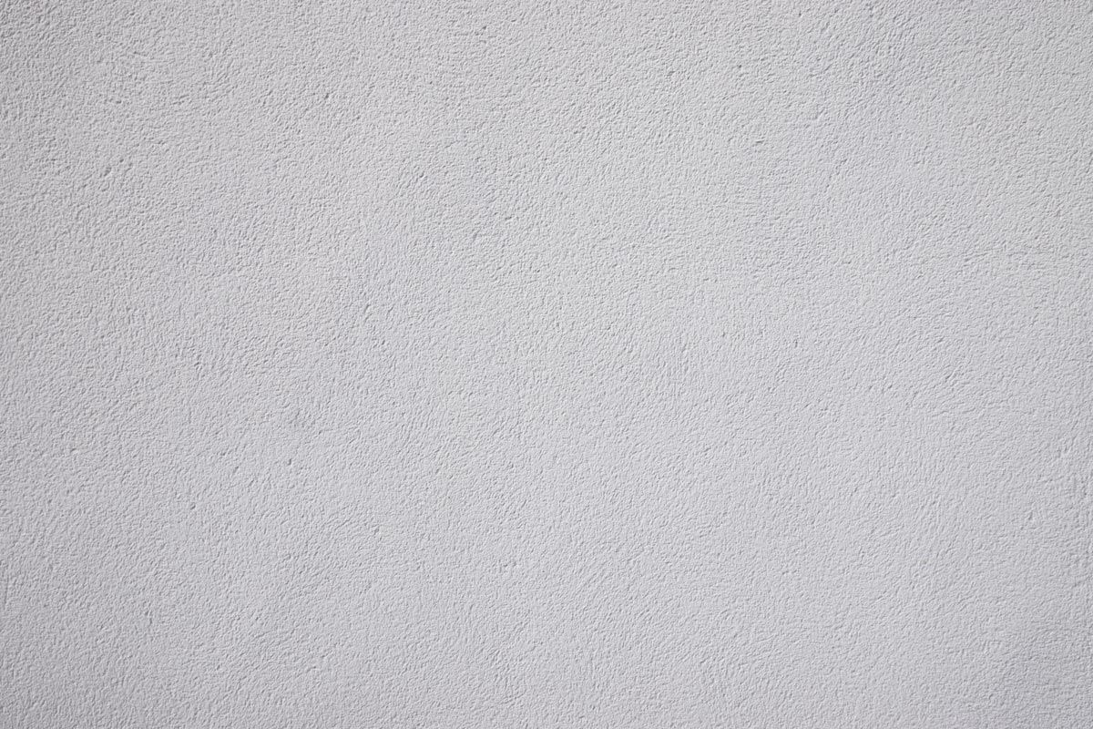 Une texture gris clair mouchetée, ressemblant à du béton fin ou à une surface de pierre.