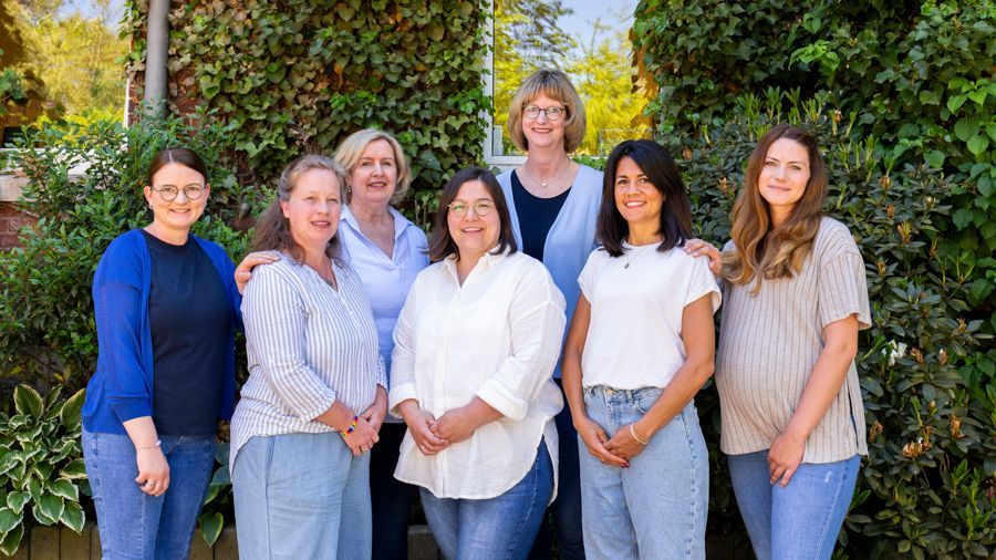 Eine Gruppe von Menschen legt ihre Hände im Kreis zusammen.