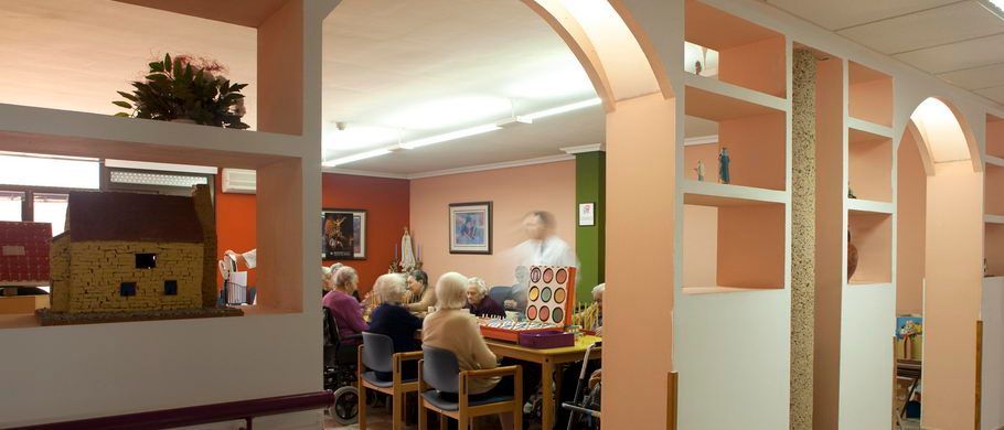 Un grupo de personas están sentadas alrededor de una mesa en una habitación.