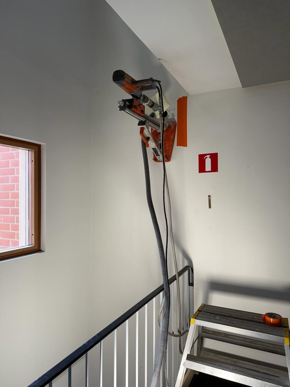 Welder in protective gear welding metal frame, sparks flying.
