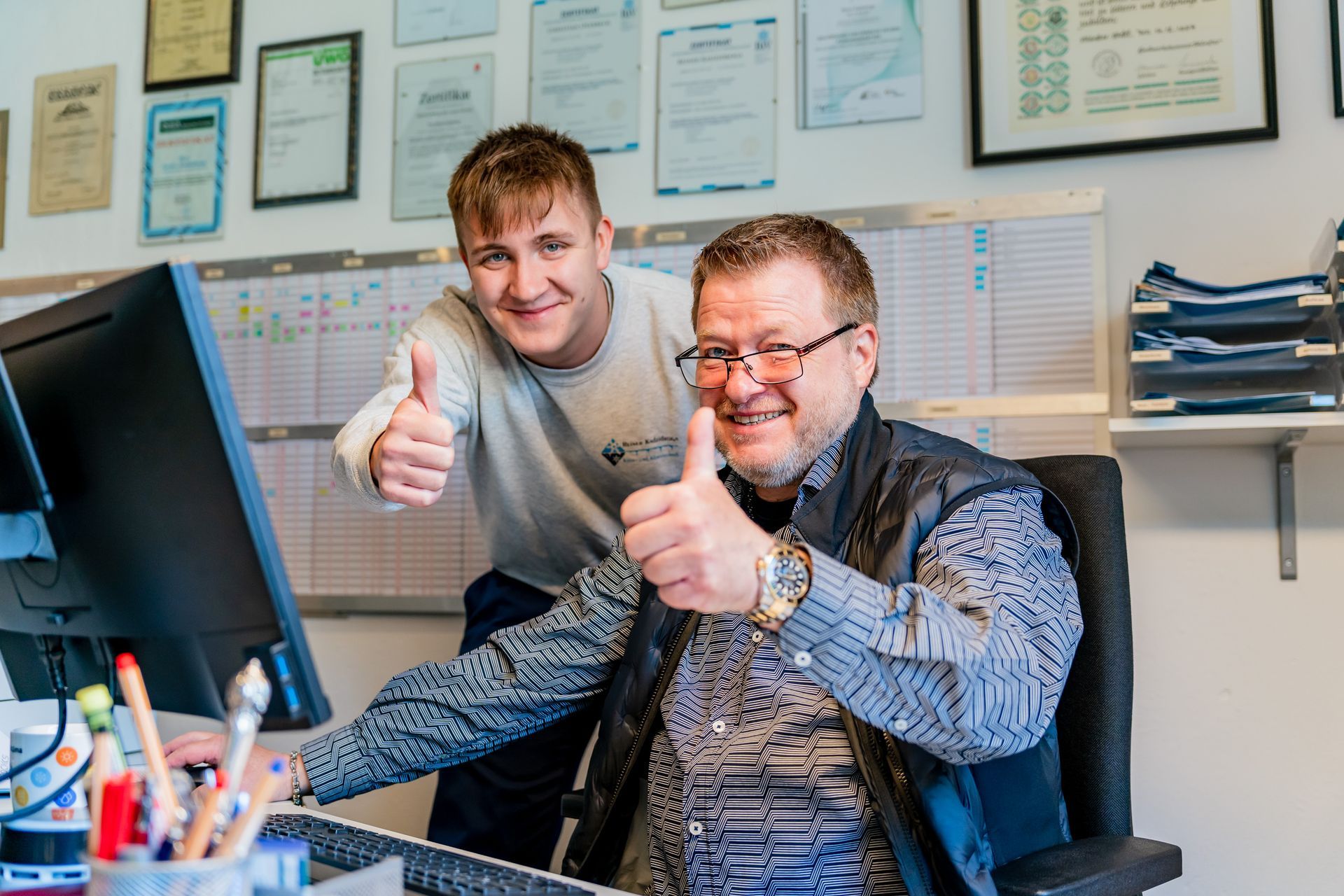 Reiner Kadzidroga und ein Mitarbeiter halten einen Daumen in die Kamera.