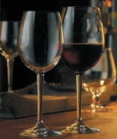 Dos copas de vino están sobre una mesa de madera.