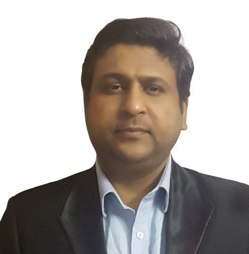 Man in a blazer and light blue shirt, looking at the camera, against a white background.