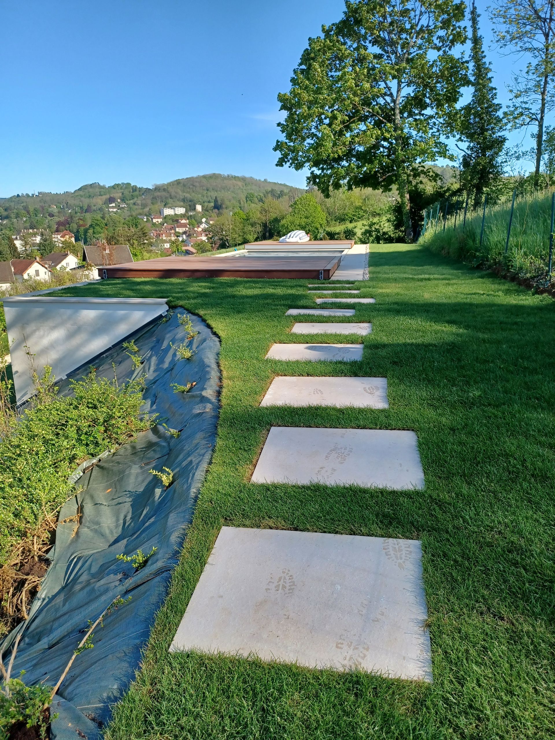 Un chemin fait de dalles posées sur une pelouse