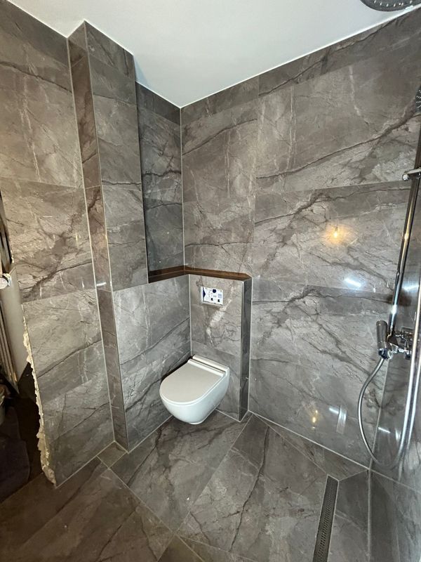 Ein Badezimmer mit Toilette und Dusche.