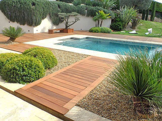 Une terrasse en bois et végétalisation autour d'une piscine