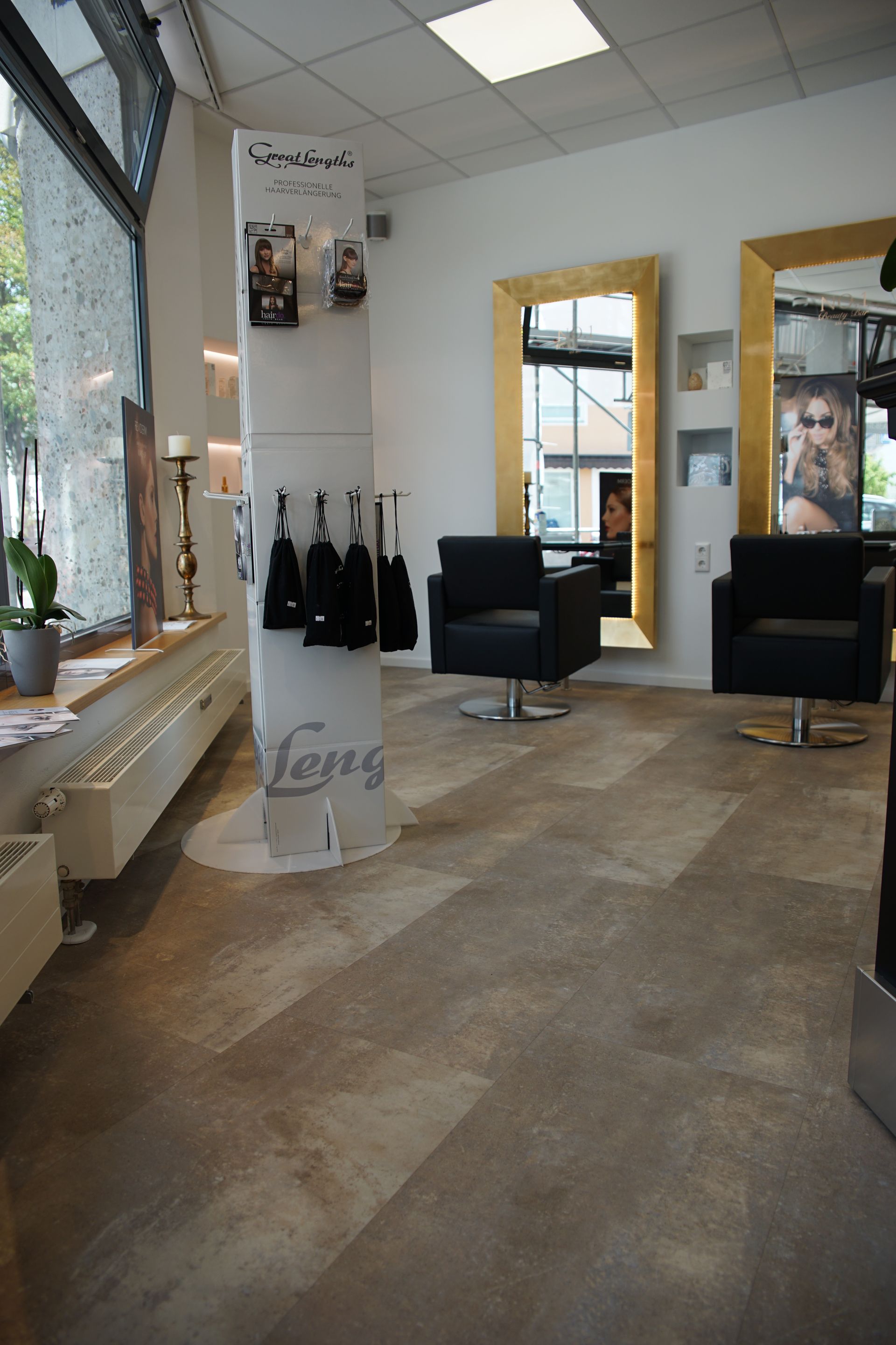 Ein salon mit zwei Stühlen und einem Spiegel und einem Display