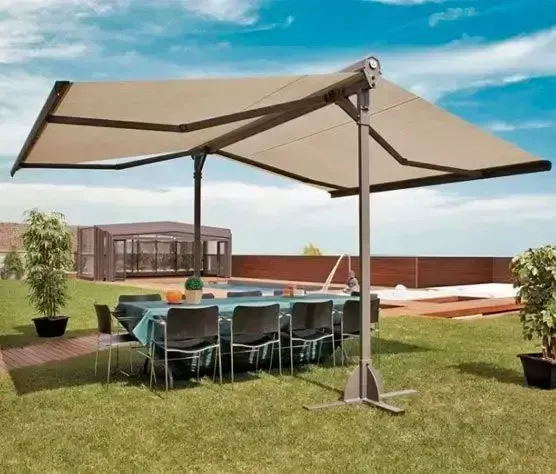 Un patio con una mesa y sillas bajo un toldo.
