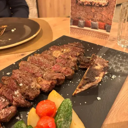 Un plato de carne y verduras en una mesa