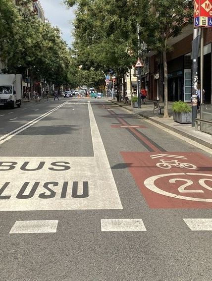 Una calle con un carril bus y un carril bici pintados en ella.