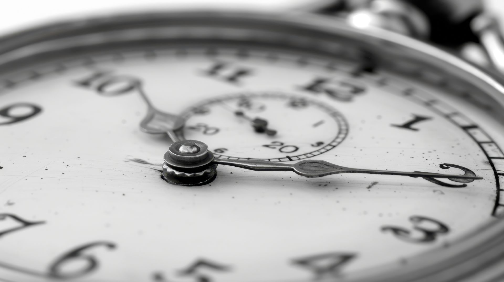 Une photo en noir et blanc d'une horloge avec les aiguilles sur les chiffres 10 et 12
