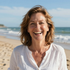 middle aged woman at beach smiling at camera