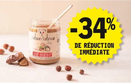 34 % de réduction immédiate sur le pot de 570 grammes de pâte à tartiner de la marque Que Bueno. Présentation du pot avec des noisettes et des morceaux de Bueno sur le côté.
