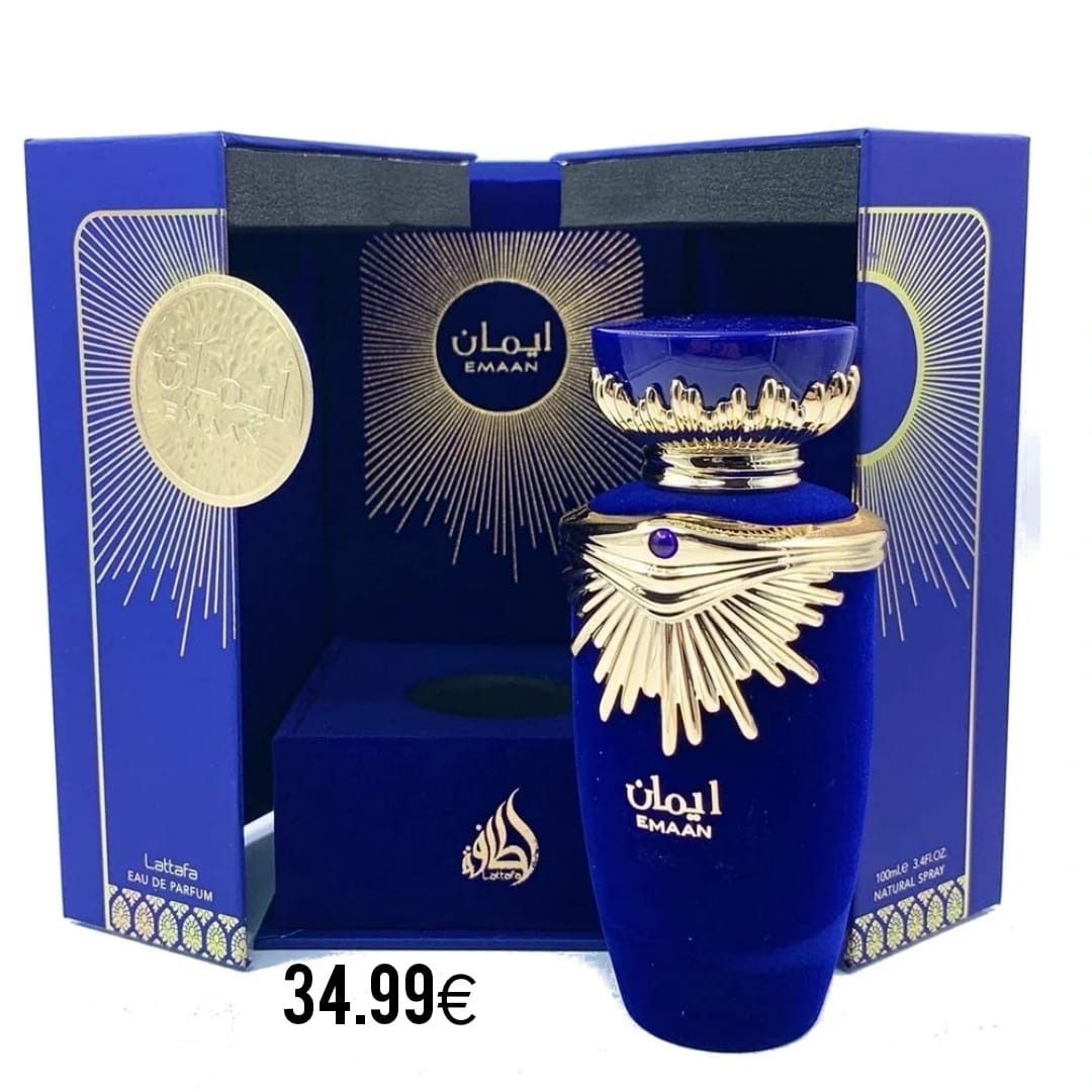 Un frasco de perfume está delante de una caja azul.