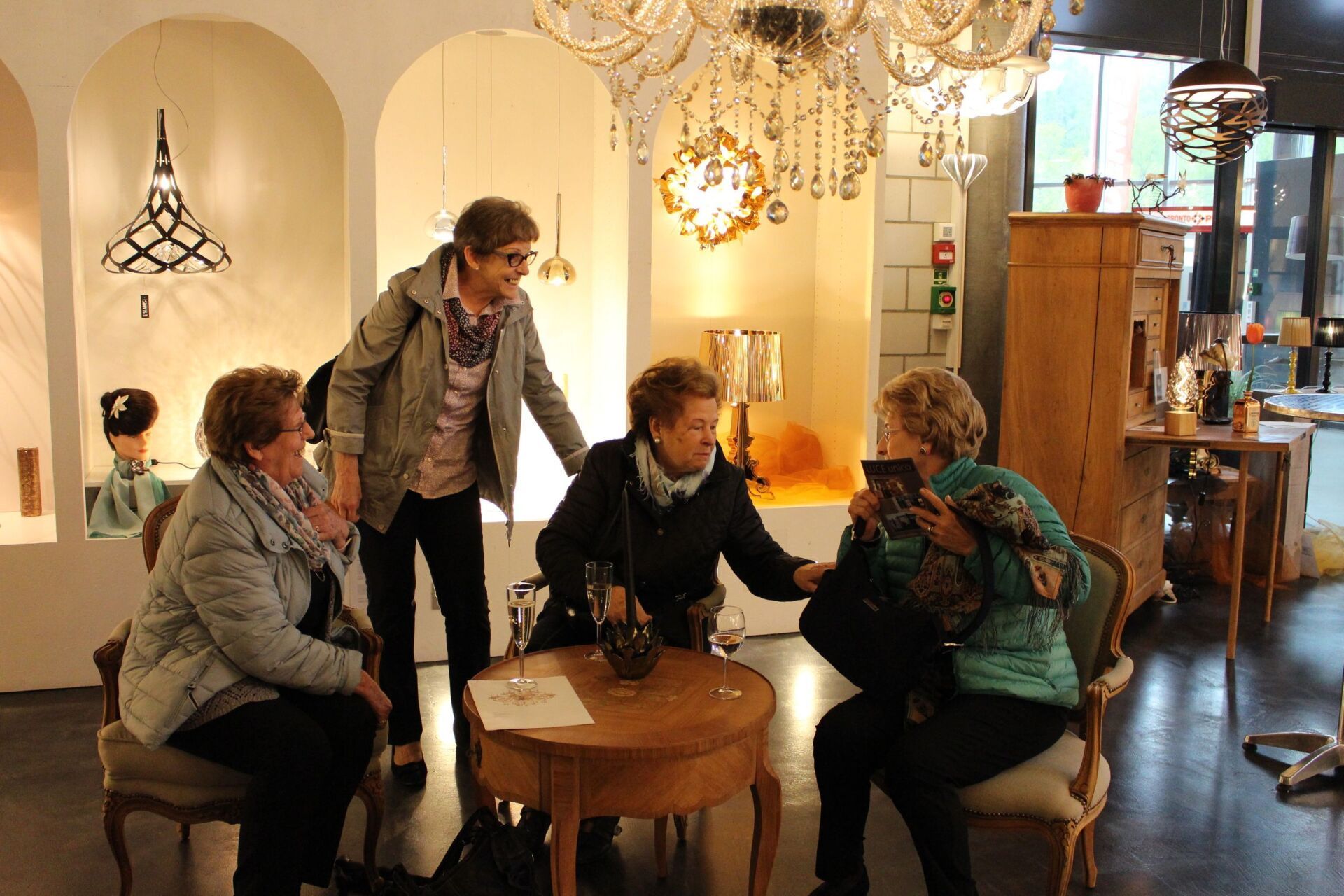 Eine Gruppe von Frauen sitzt in einem Raum um einen Tisch herum.