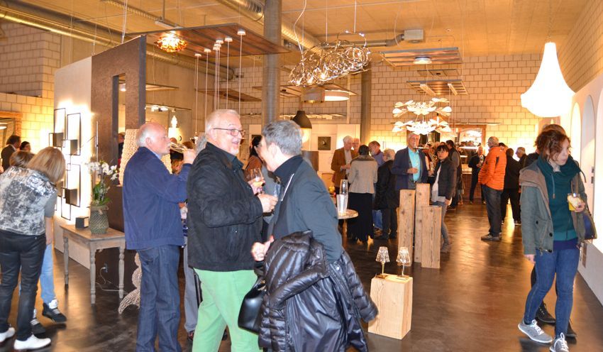 Eine Gruppe von Leuten steht in einem Raum und unterhält sich.