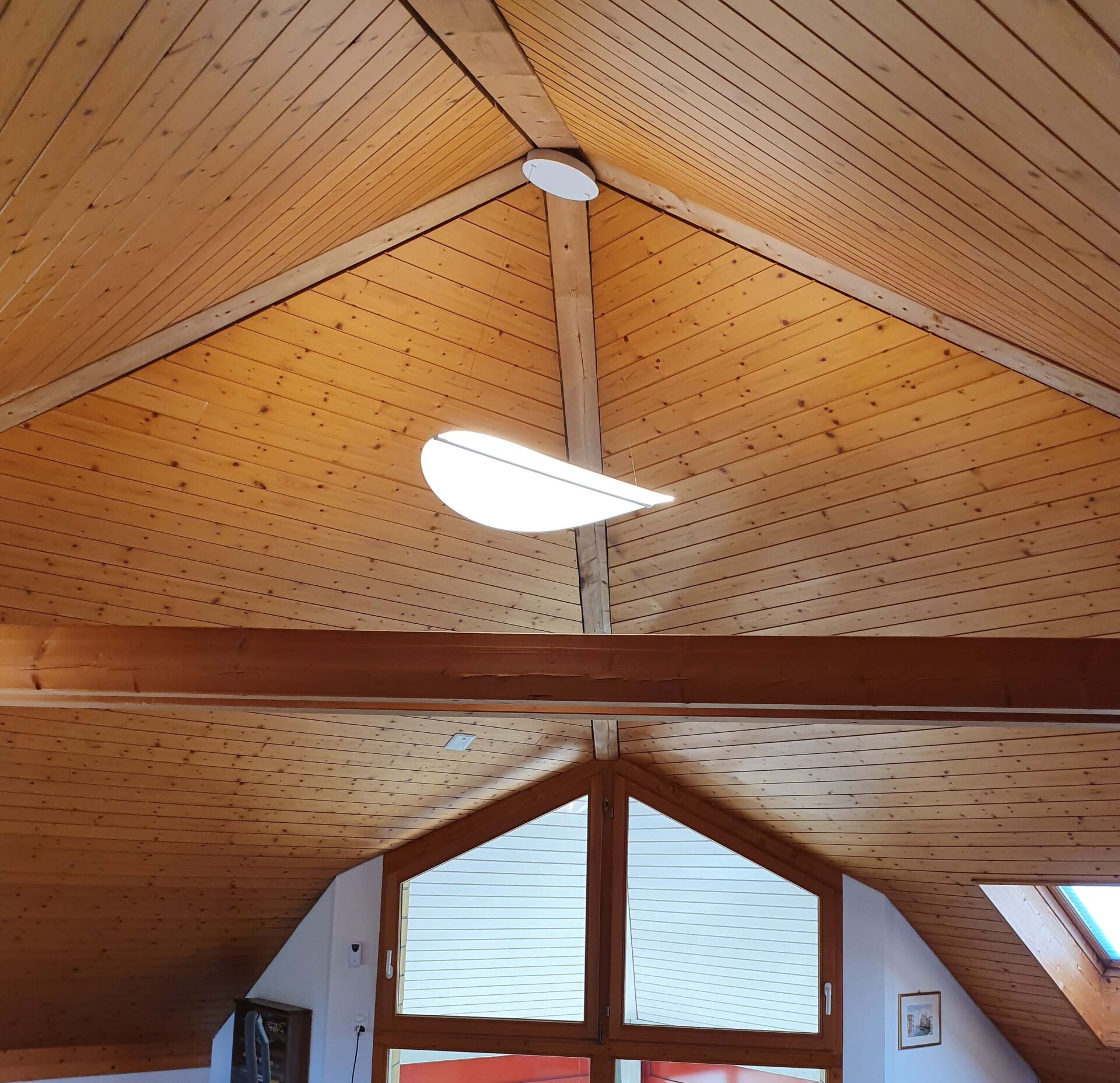 Eine Holzdecke, an der eine Lampe hängt