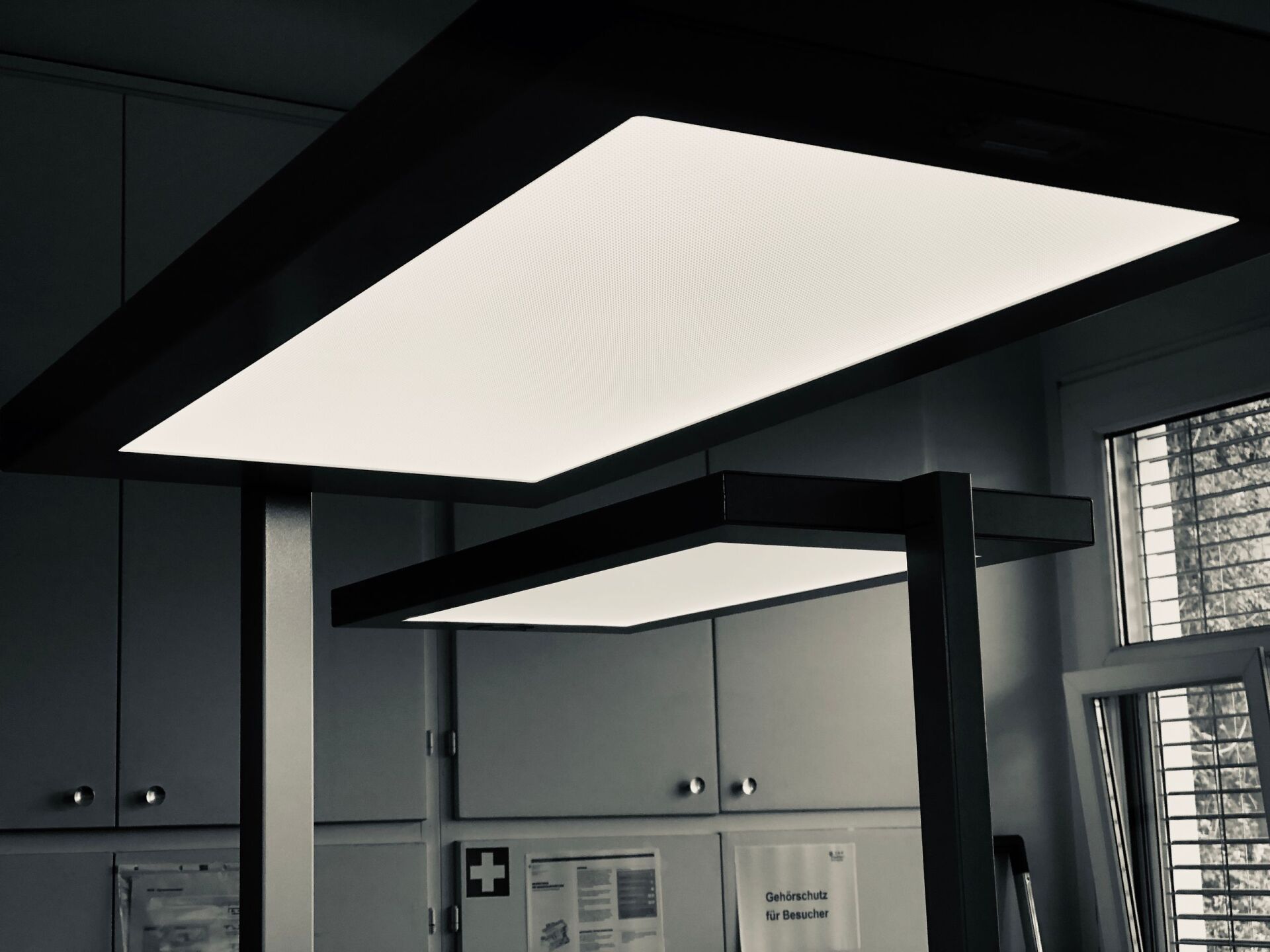 Ein Schwarzweißfoto eines Raumes mit einer von der Decke hängenden Lampe