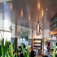 Ein Restaurant mit vielen Lichtern, die von der Decke hängen.