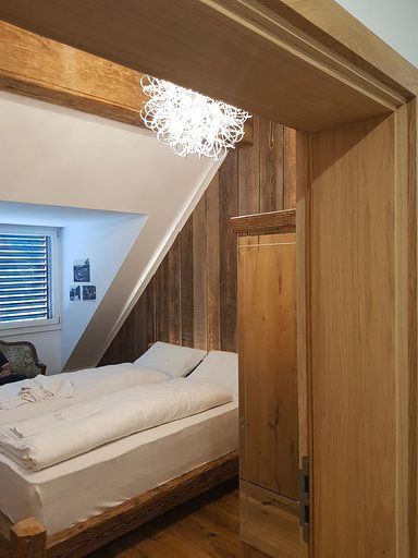 Ein Schlafzimmer mit einem Bett und einer Holzwand.