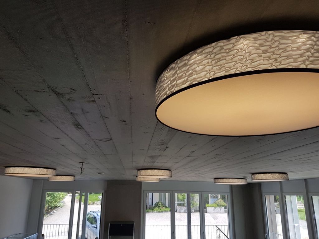 Ein Raum mit vielen Fenstern und einer Deckenleuchte