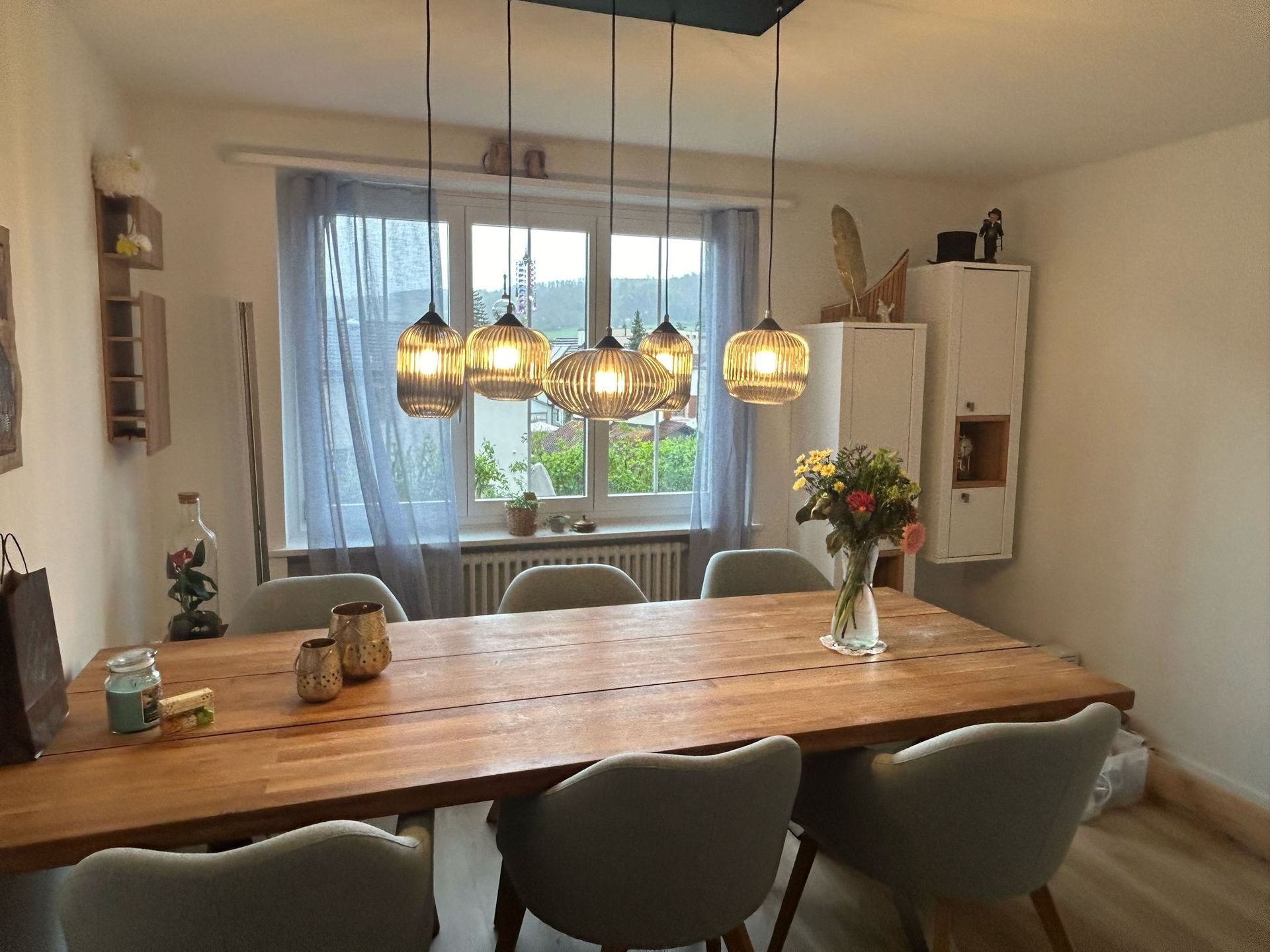 Ein Esszimmer mit einem langen Holztisch und Stühlen