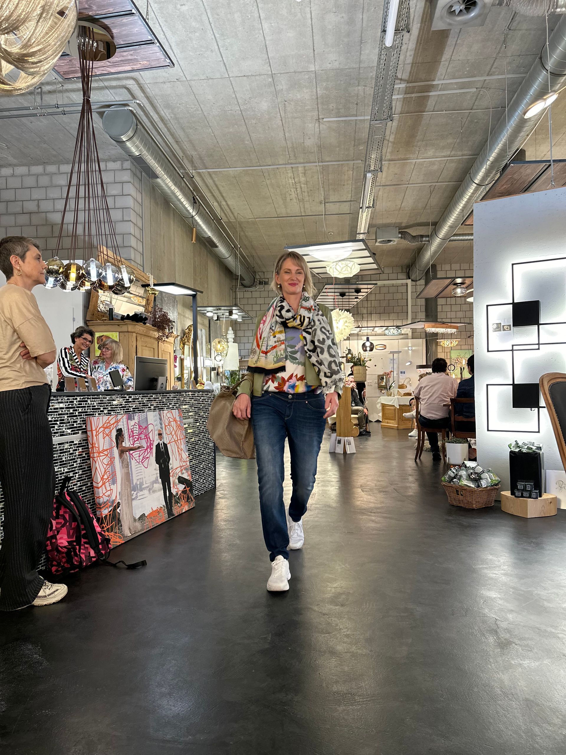 Eine Frau geht einen Flur in einem Geschäft entlang.