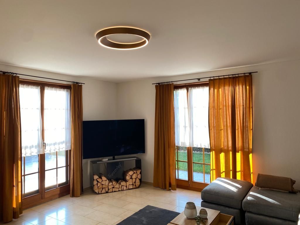 Ein Wohnzimmer mit Flachbildfernseher und Couch.