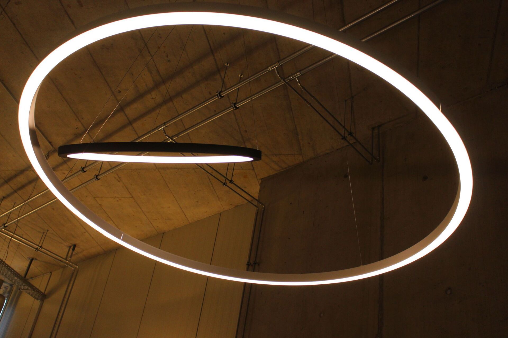 Ein kreisförmiges Licht, das in einem dunklen Raum von der Decke hängt