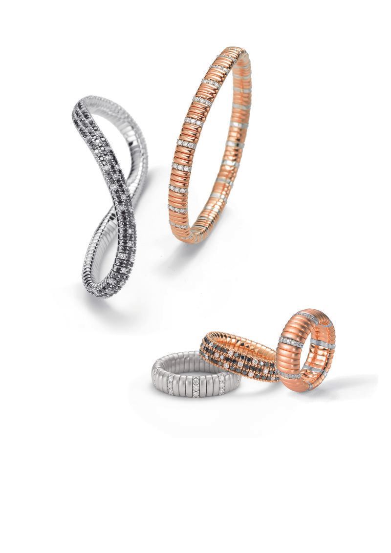 Schmuck: Diamantbesetzte Armbänder aus Silber und Roségold in verschiedenen Designs vor weißem Hintergrund.