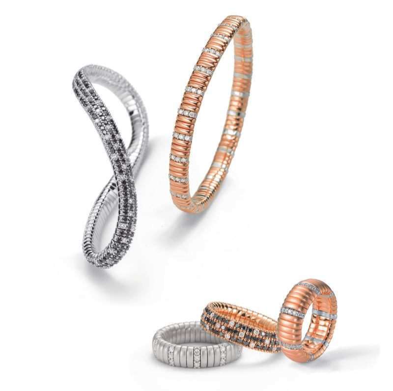 Vier flexible, diamantbesetzte Armbänder in Weißgold, Roségold und gemischten Tönen, präsentiert auf weißem Hintergrund.