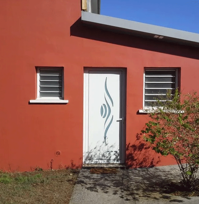 Maison rouge et sa porte d'entrée personnalisée