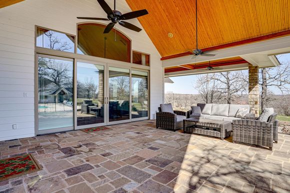 Covered outdoor patio and lounge area at Post Oak Estate