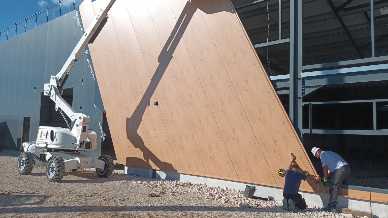 Pose de bardage imitation bois à l'aide d'une grue