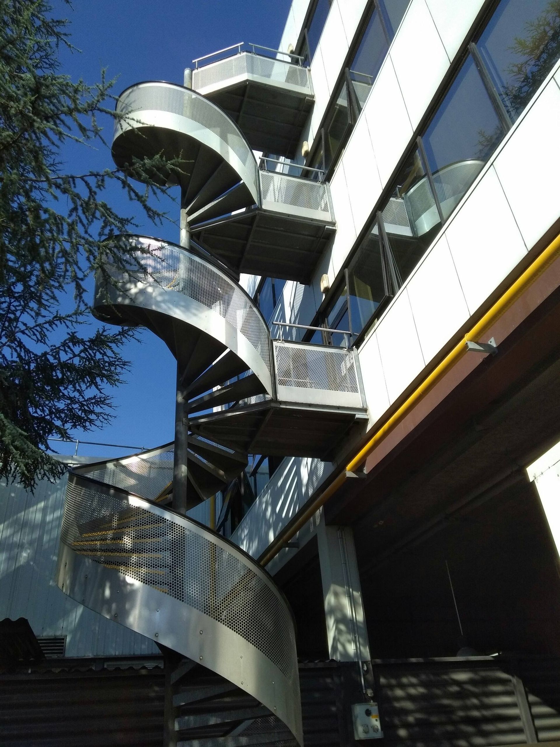 Vue en contre plongé d'un escalier métallique extérieur en colimaçon
