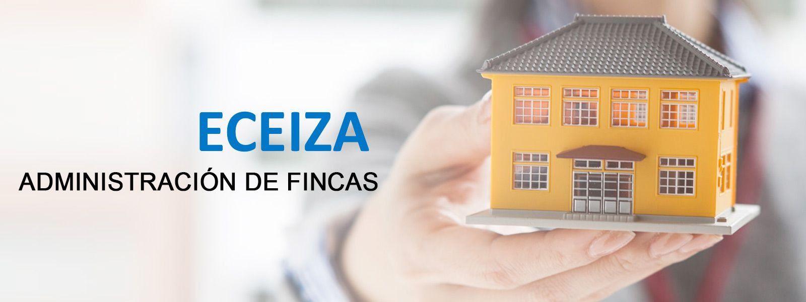 Hand holding a model house.  "ECEIZA ADMINISTRACIÓN DE FINCAS" text.  Yellow house, gray roof.
