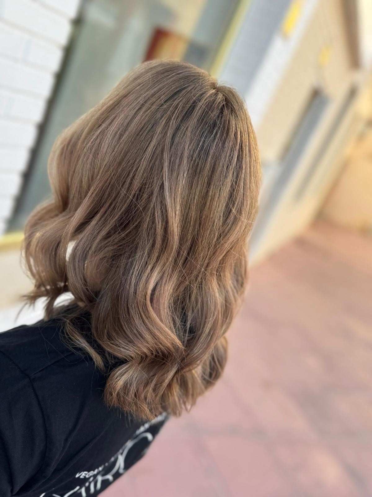 Cabello castaño ondulado y con reflejos de mujer.