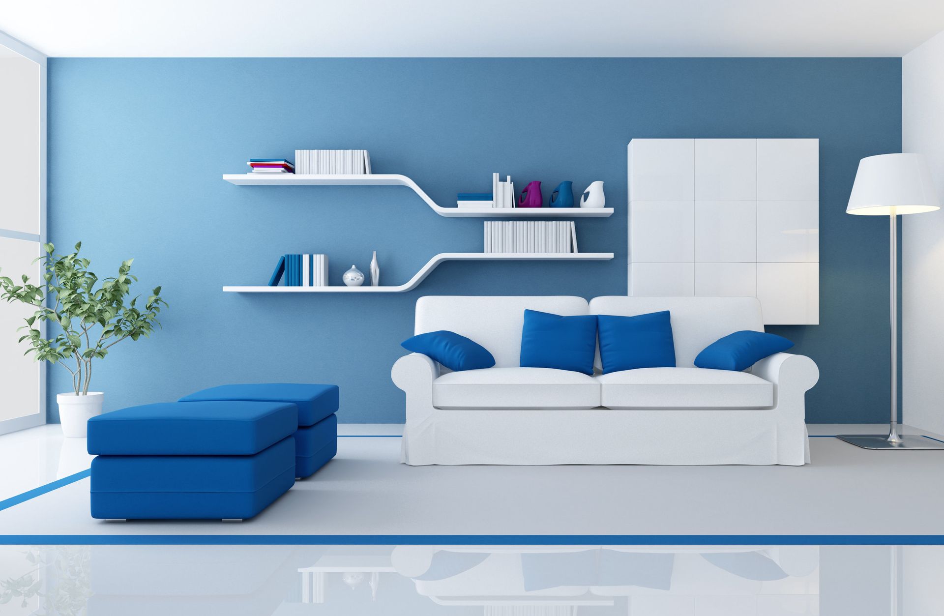 Una sala de estar con paredes azules y muebles blancos.