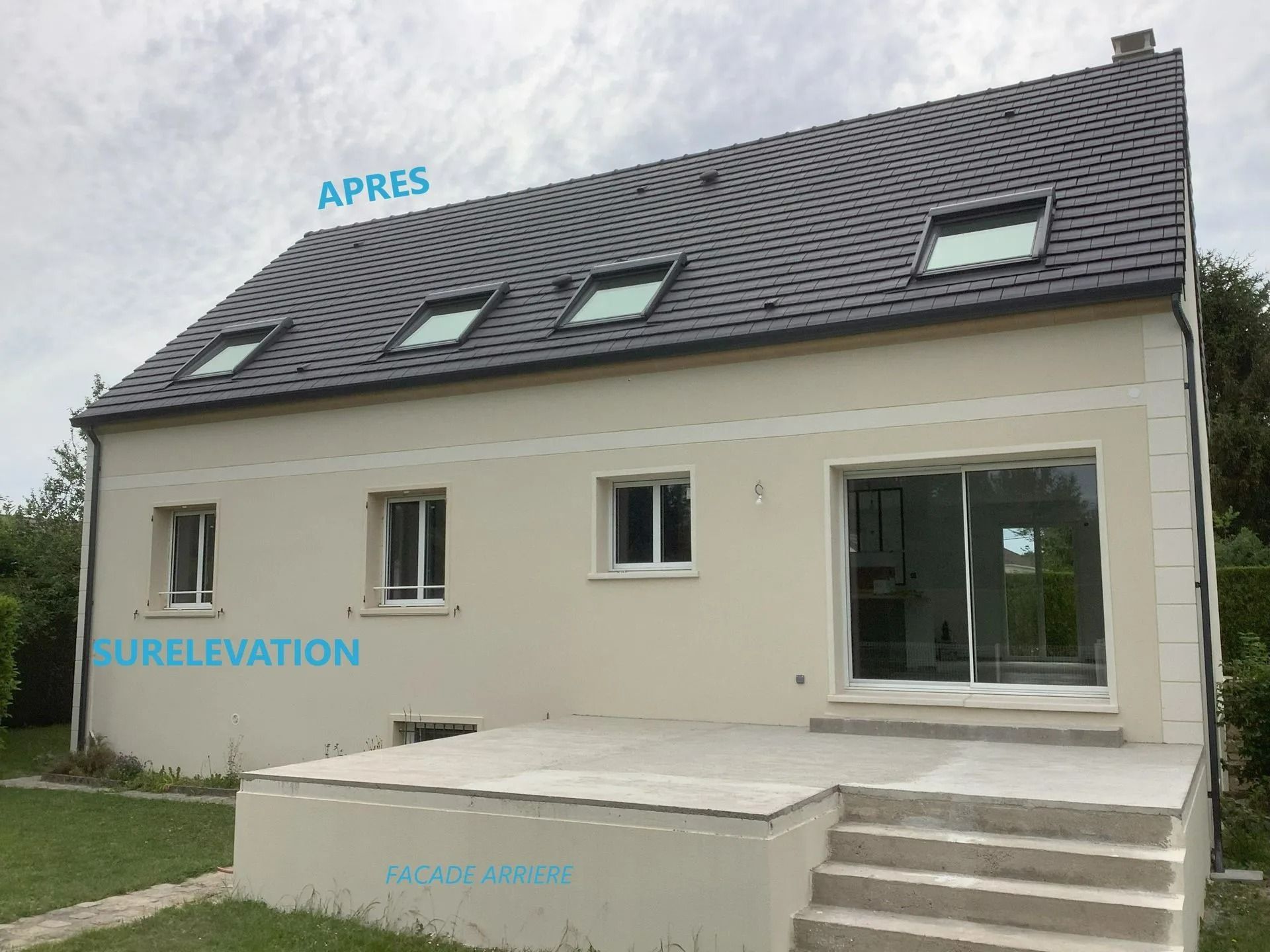 Extérieur de la maison avec toit foncé et puits de lumière, murs en stuc clair et terrasse en béton.