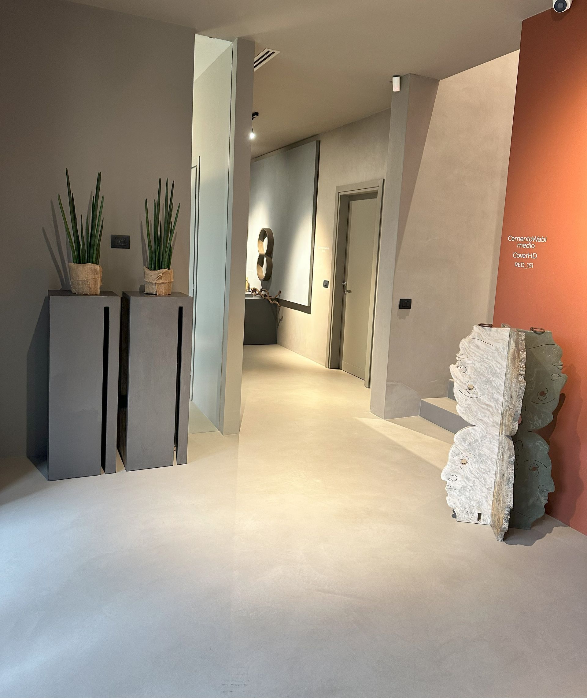 Ein Flur mit ein paar Topfpflanzen auf Ständern