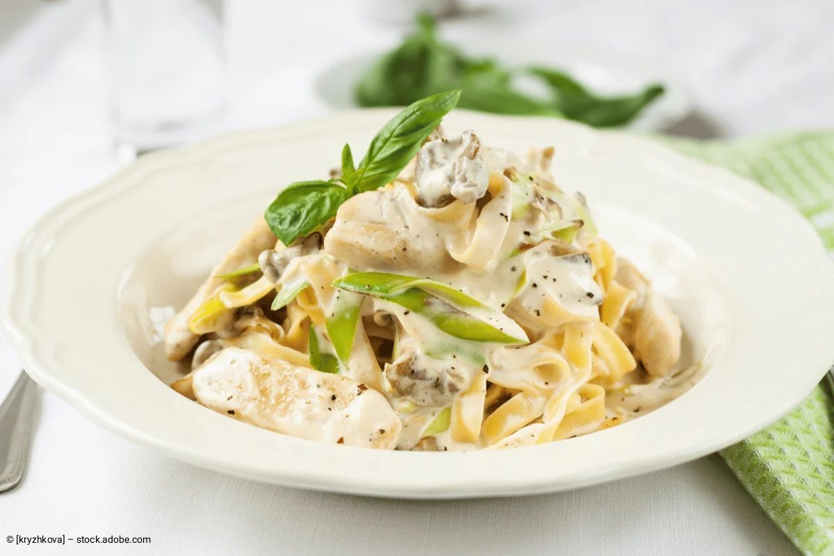 Pastagericht mit Garnelen, Rucola und Garnitur auf einem dekorativen Teller.